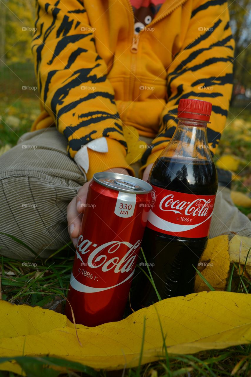 coca cola in hand child drinking coca cola outdoor