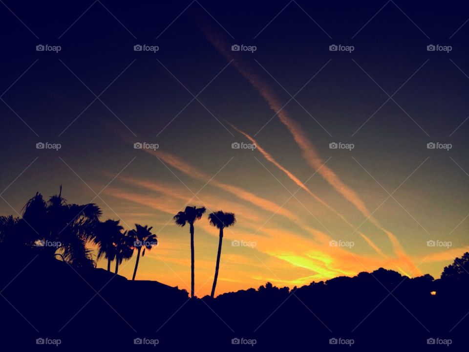 Sunset with airplane tracks in the sky