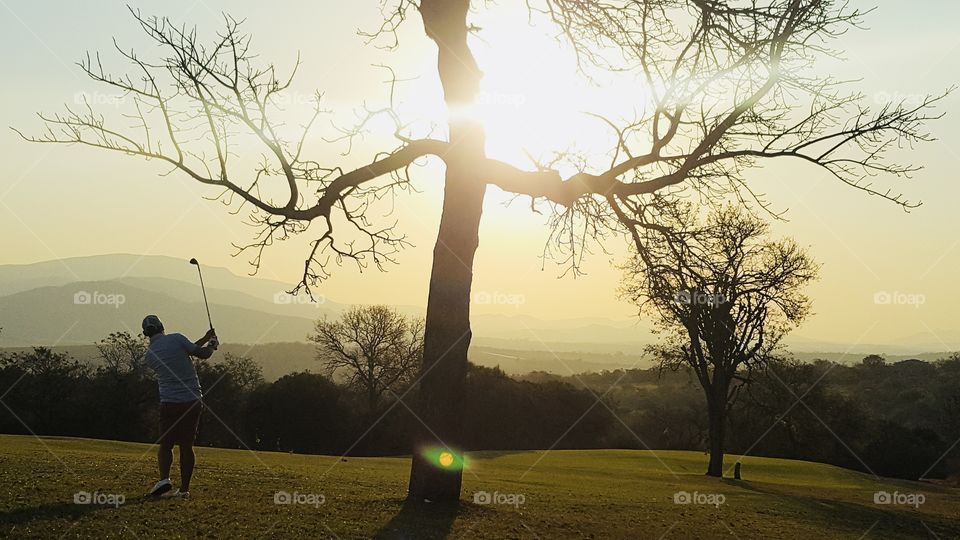 Golfing during sunset