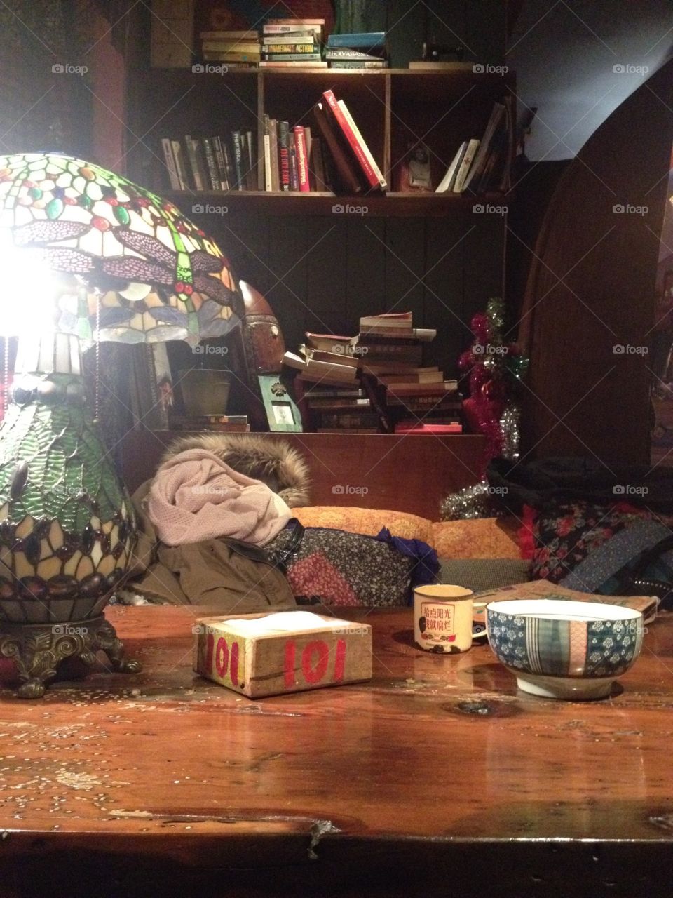 Stained glass lamp on the table in an art coffeeshop with books