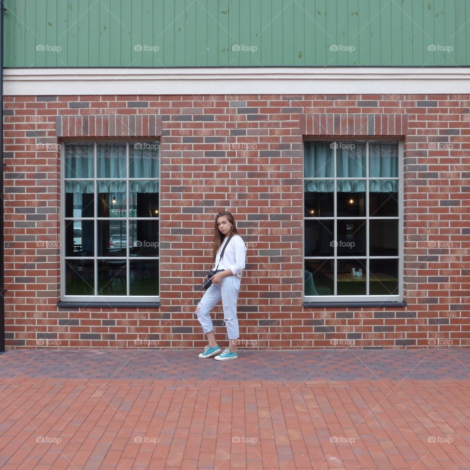 photographer girl near brick wall