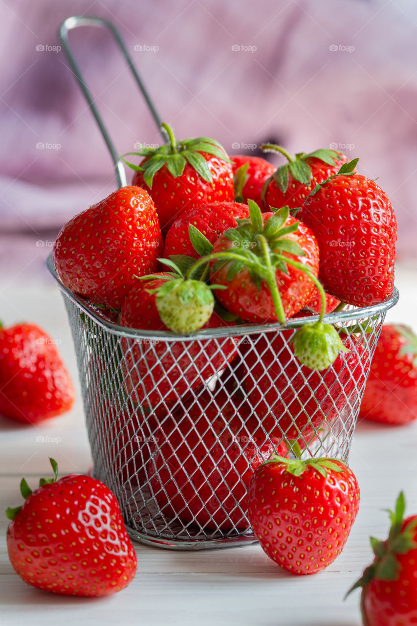 red strawberries in a small basket