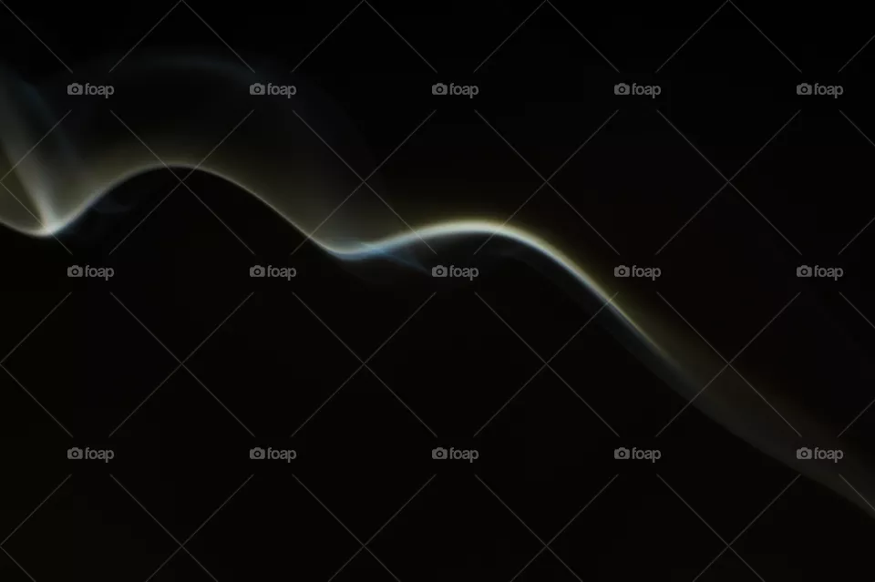 Smoke scented candles on a black background