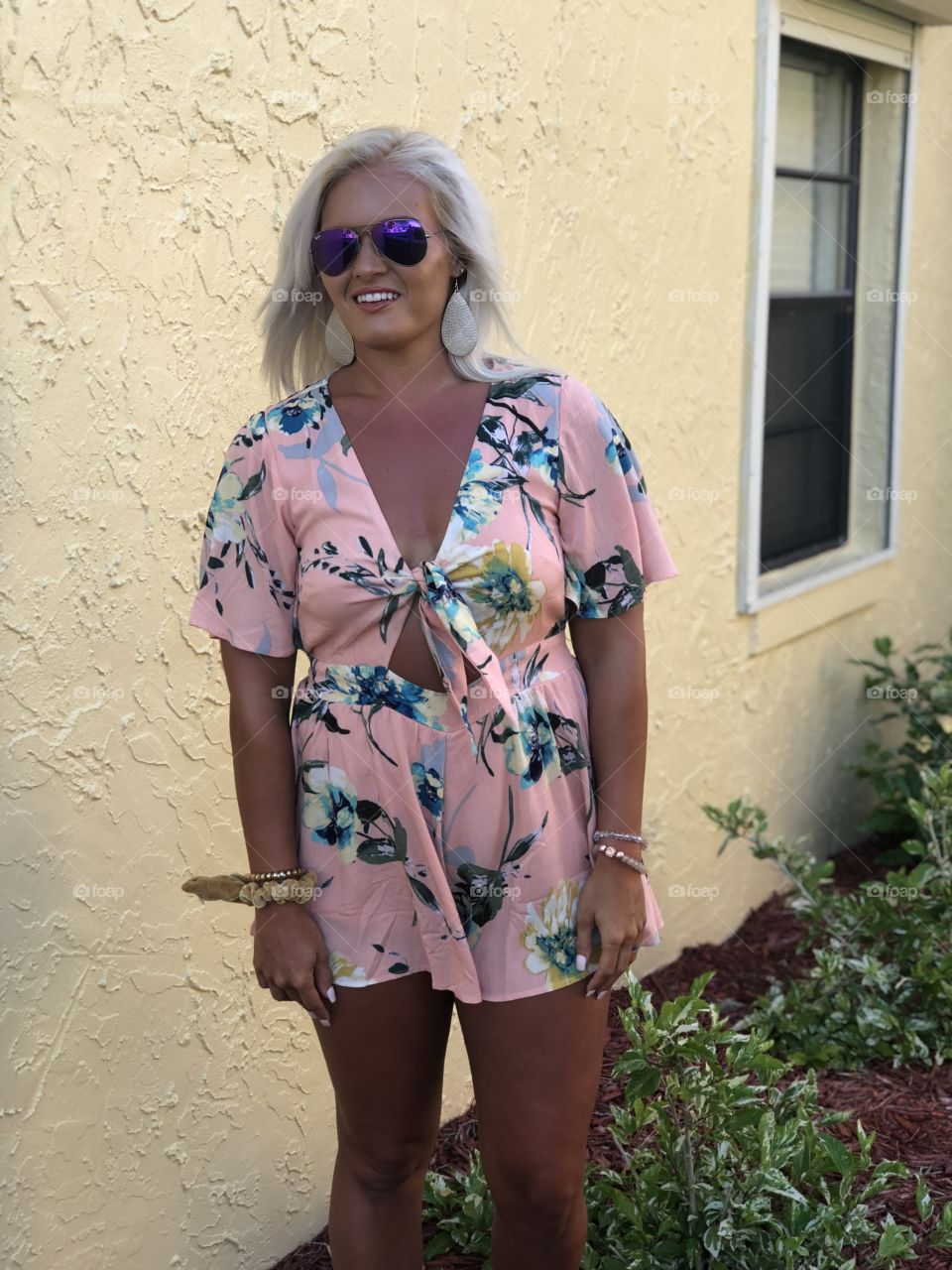 Blonde girl models sexy tropical print romper on vacation as she heads out to dinner in Florida 