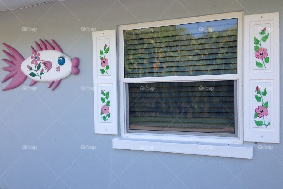 Pink floral window shutters and matching fish
