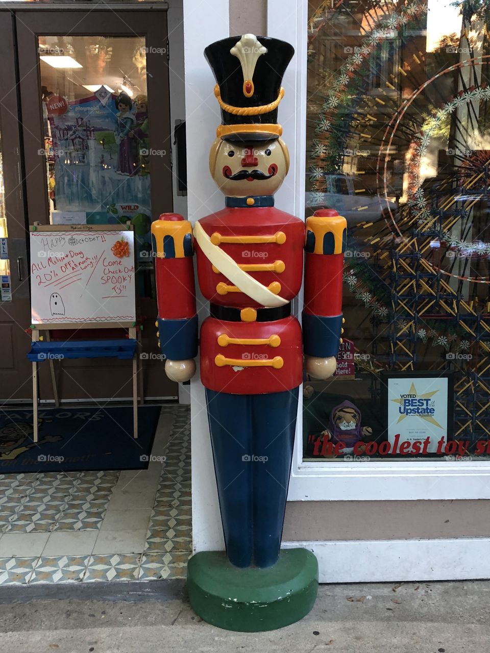 Life-size classic toy soldier standing at entrance to toy shop.