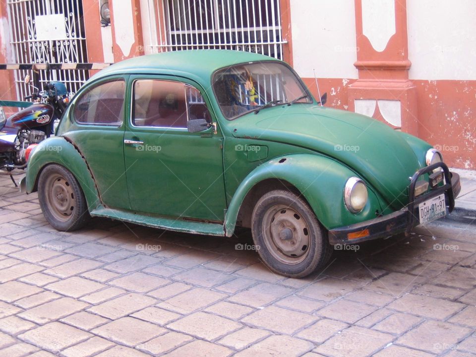 Old green car in a street