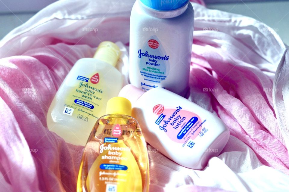 Johnson and Johnson baby products on a pink background side flat lay 