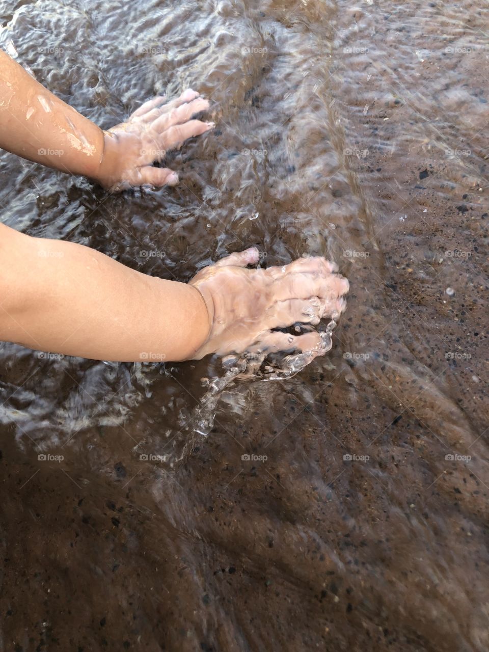 Child’s hands in water