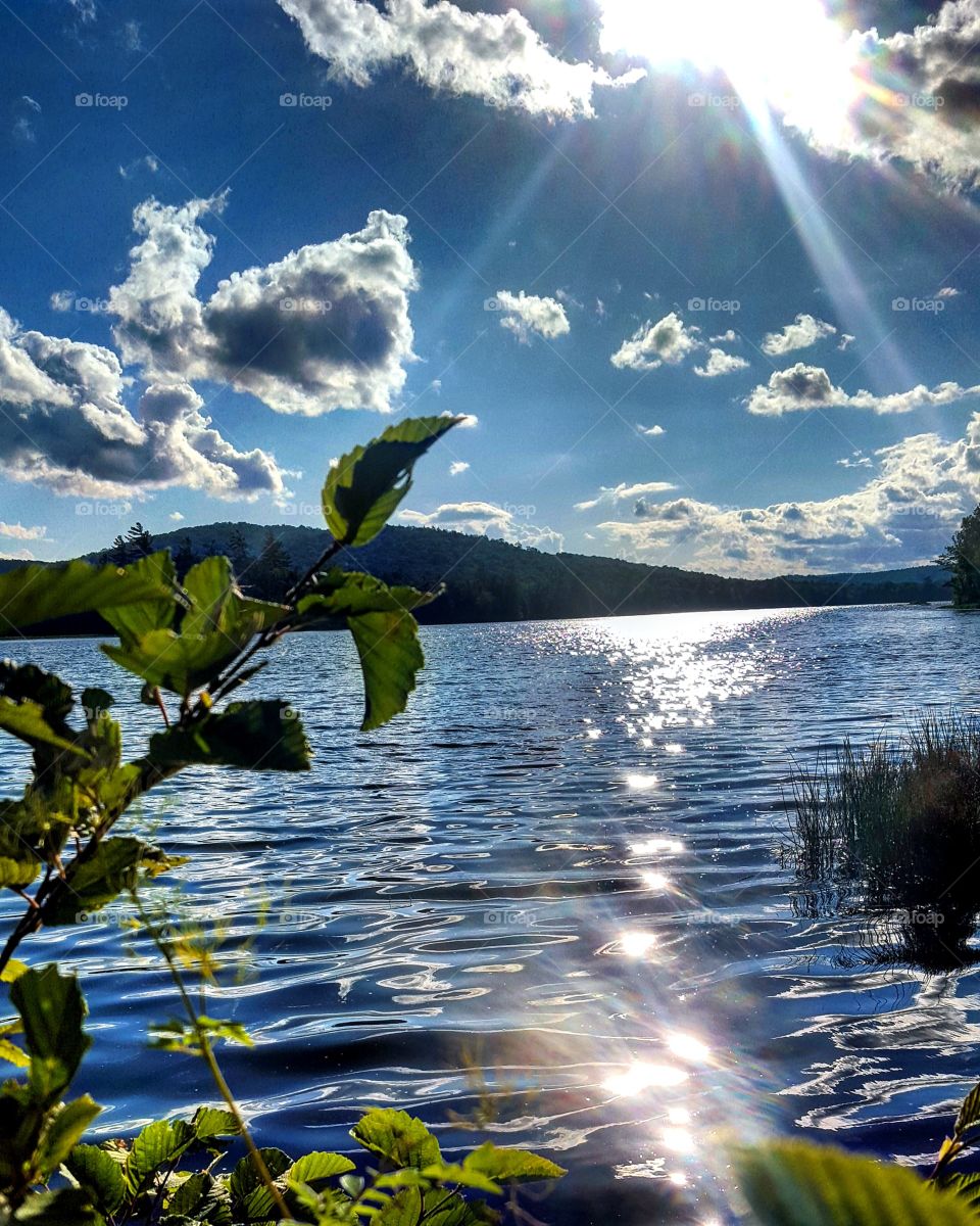 Scenic view of lake against cloudy sky