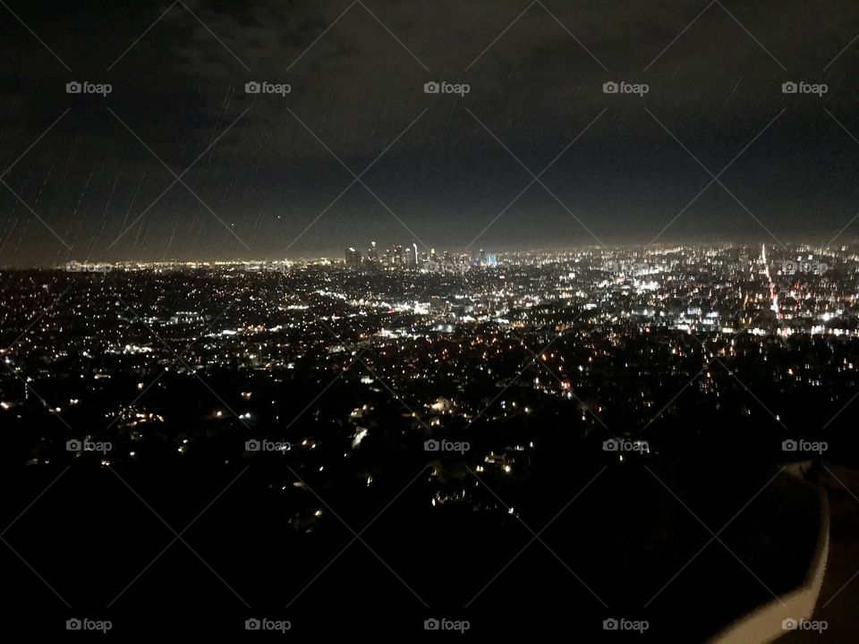 Beautiful photograph of the bright lights overlooking Los Angeles at night time 