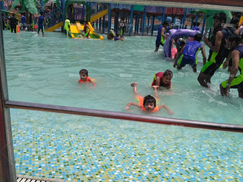 Swimming kids in pool