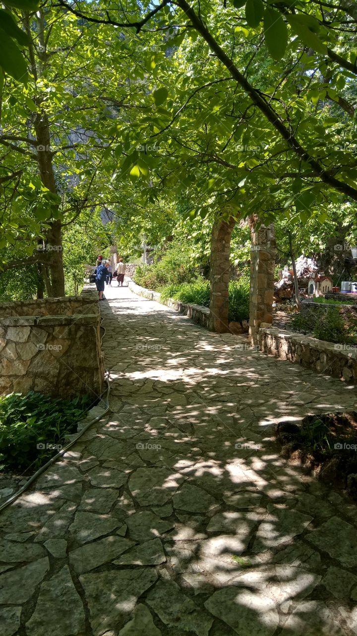 Walking through the shadows of the trees in St Vlasios in Korinthia,Greece