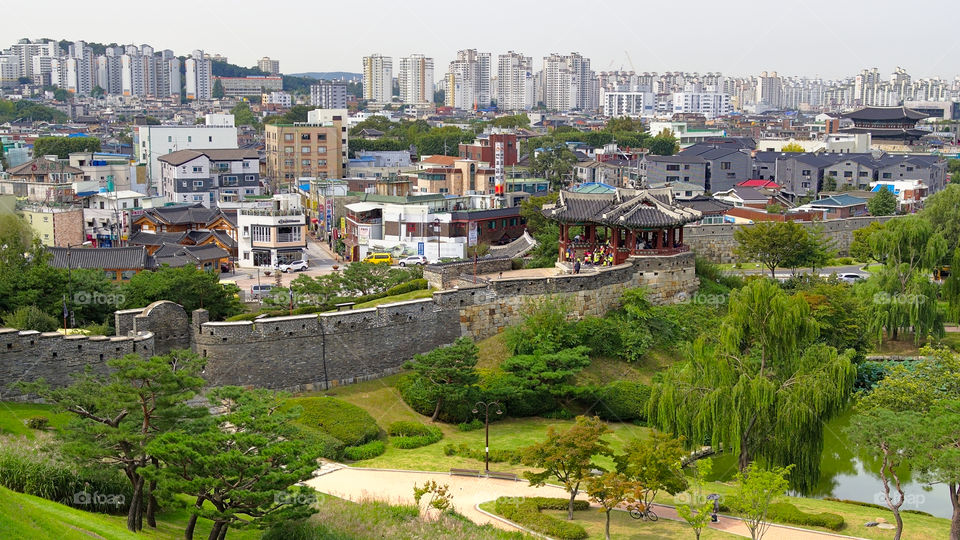 The past and present (centuries old Hwaseong Fortress wall and the modern city of Hwaseong in South Korea)