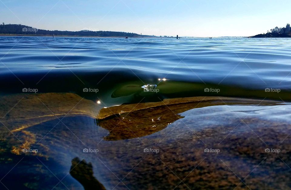 Clear wave breaking on a rock