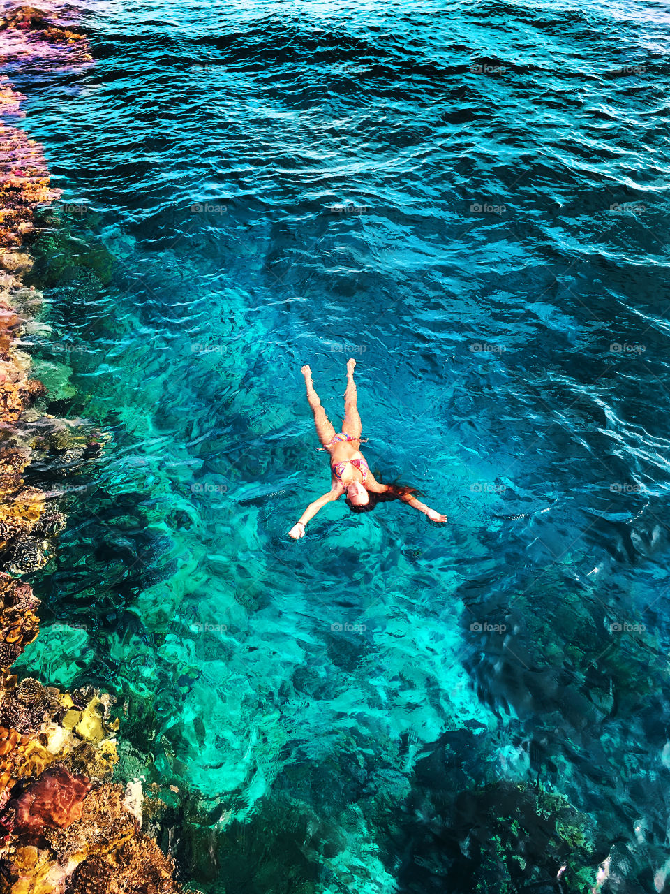 Swimming in the blue coral sea water 