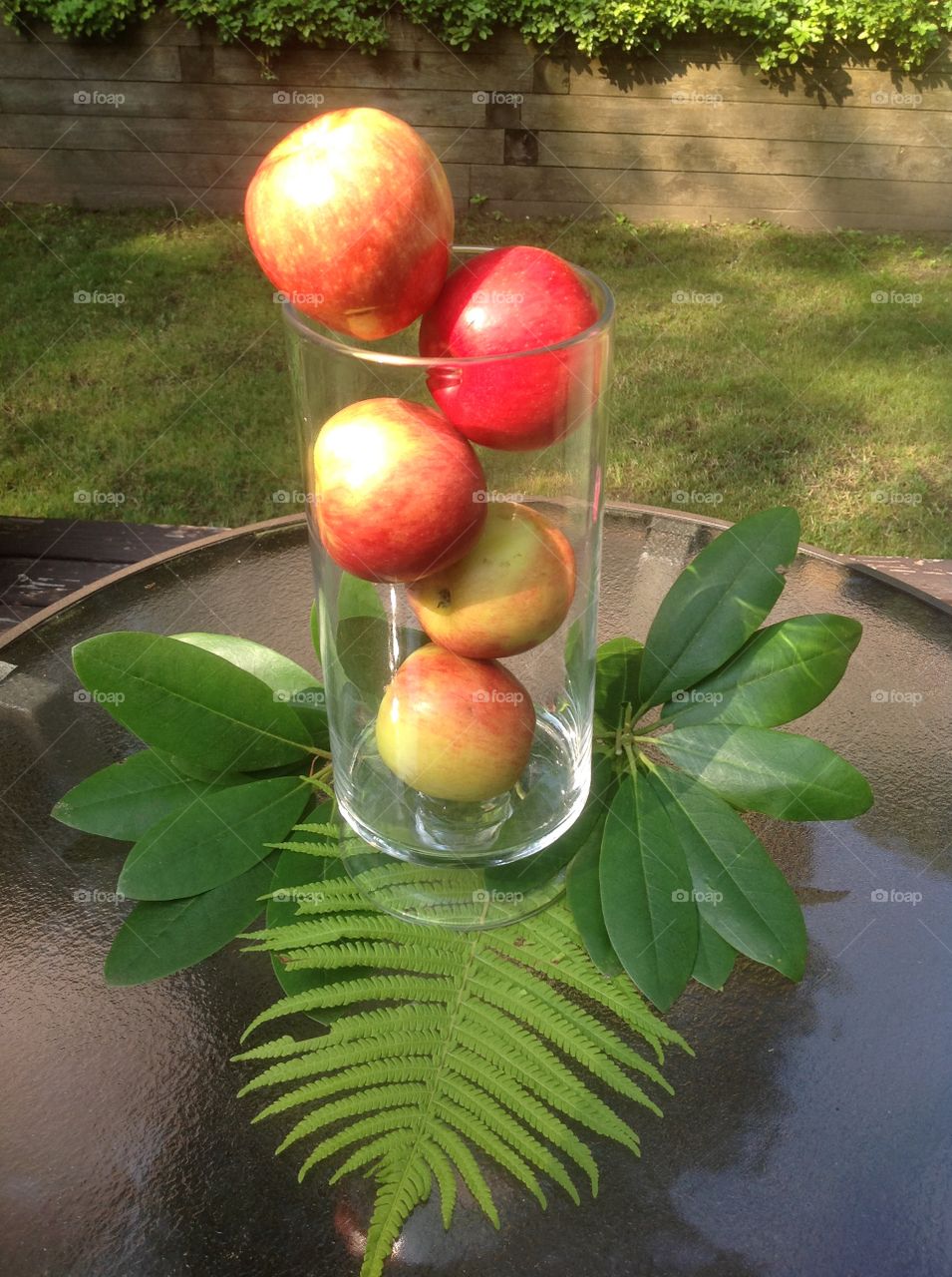 Apples in a vase as a centerpiece for a table.