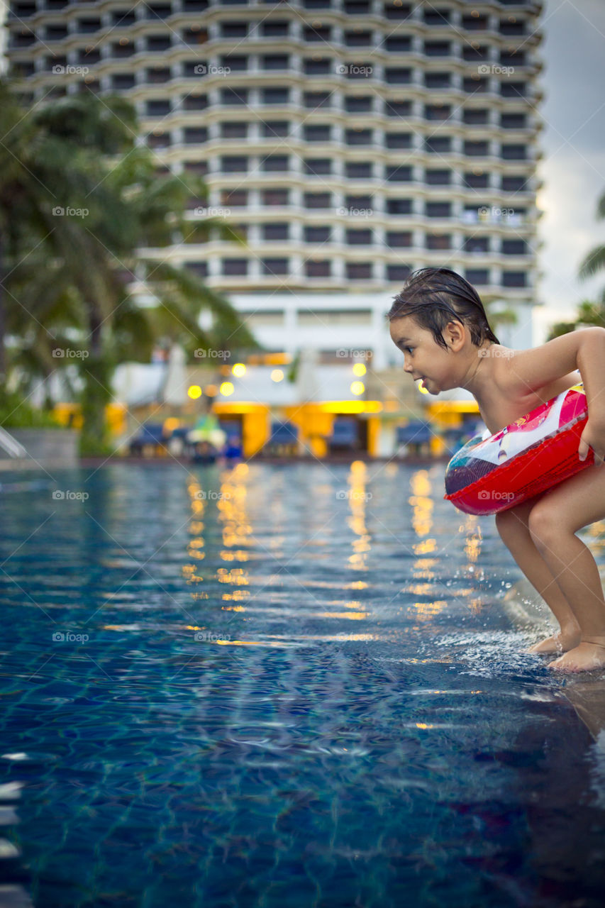 young boy ready to jump into the pool . model Thitiwin Dupont 