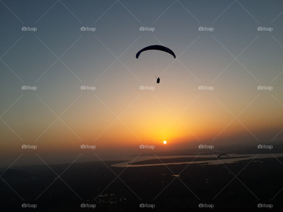 Paraglider in the evening sky
