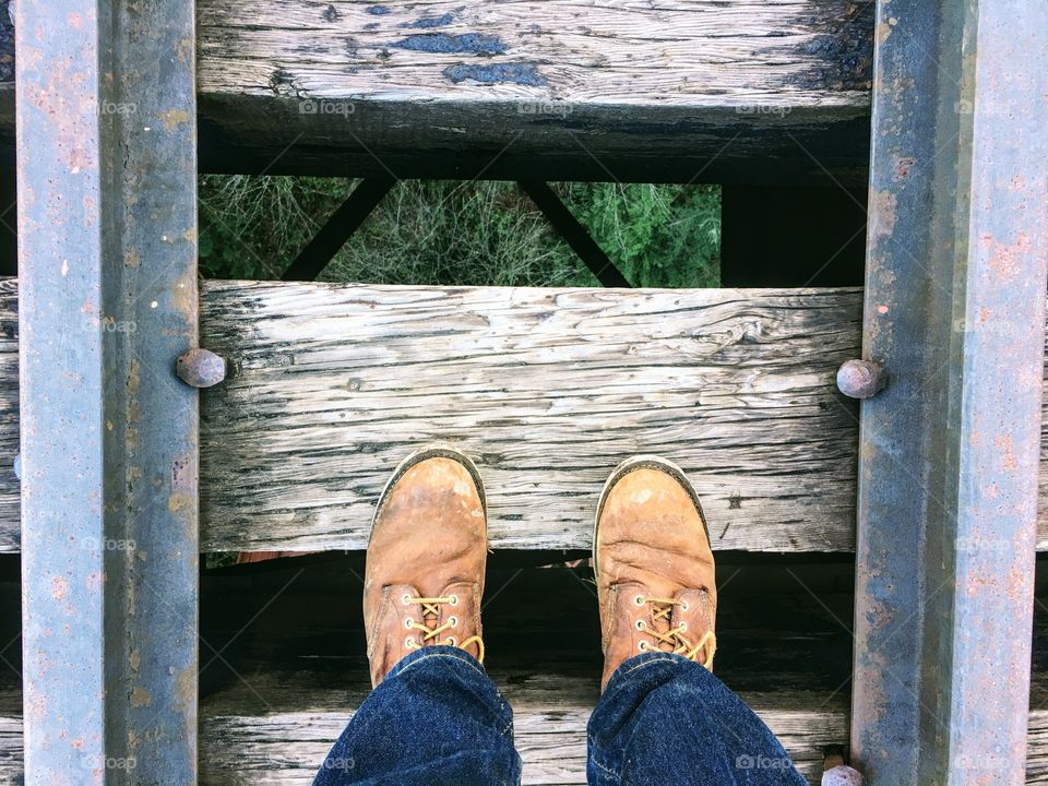 Hiking boots on the railroad tracks. 