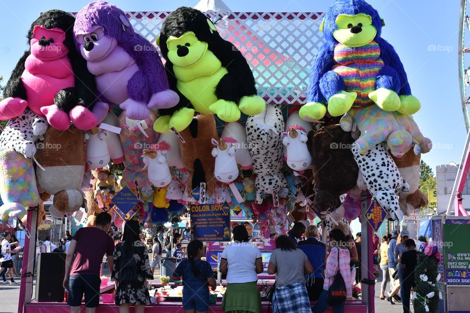 People at a stall in a summer town fair.