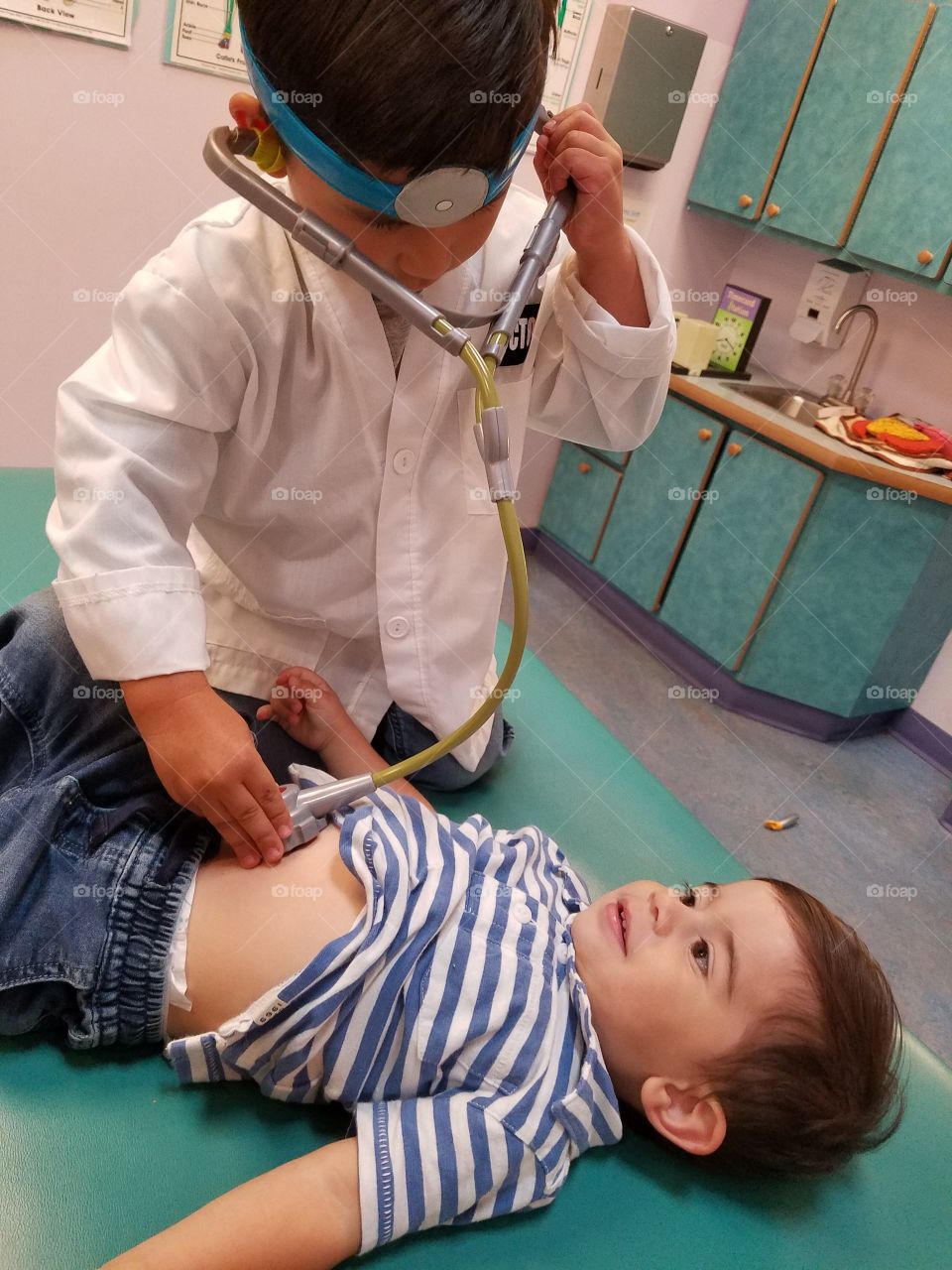 Boy checking patient in clinic