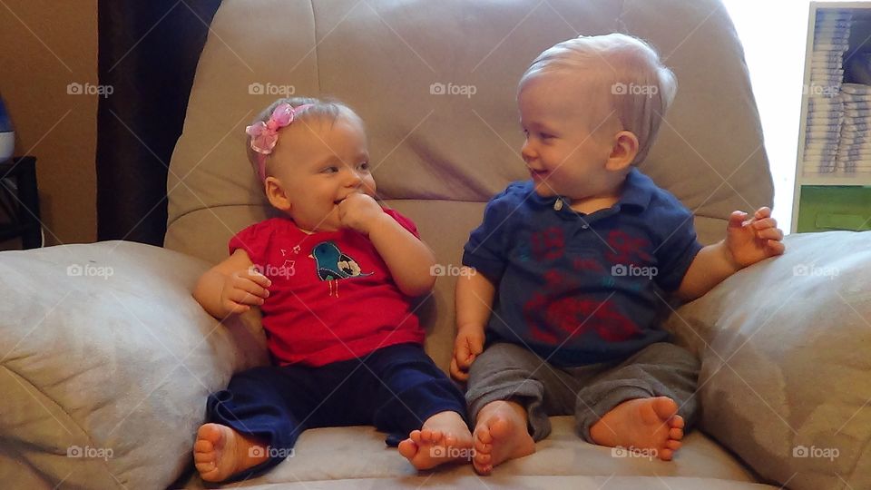 Siblings Smiling at each other. Twins smiling at each other
