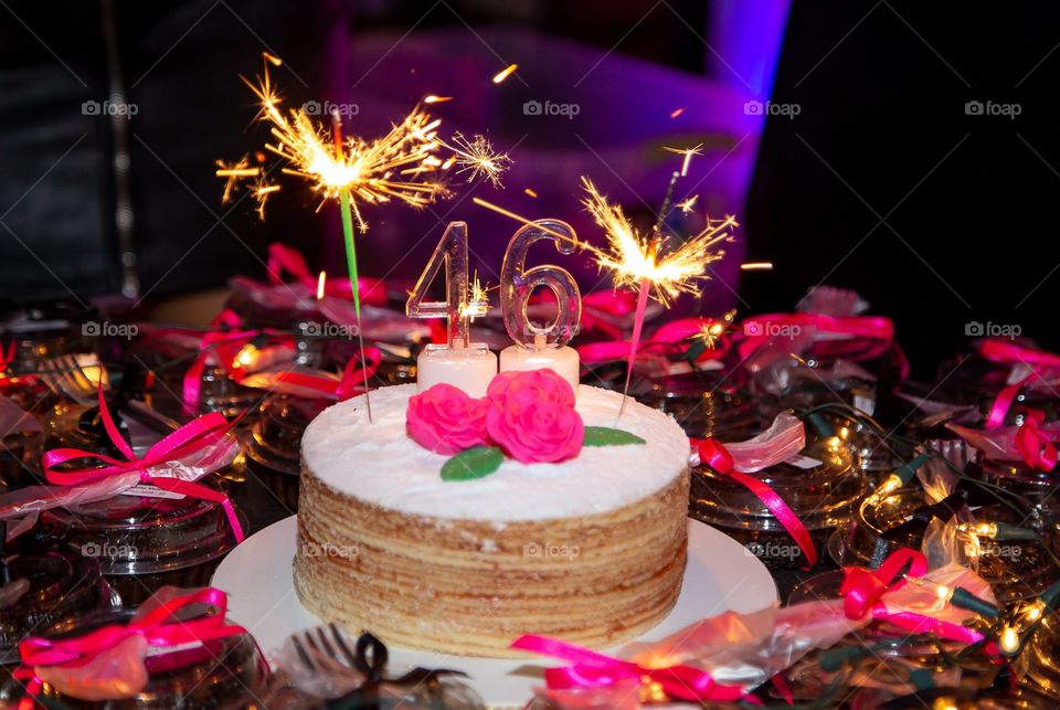 Birthday cake on black and pink background 
