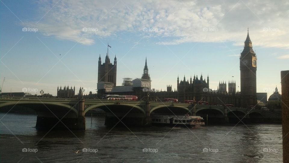 Thames River with double-decker buses and Big Ben, London, England, UK.