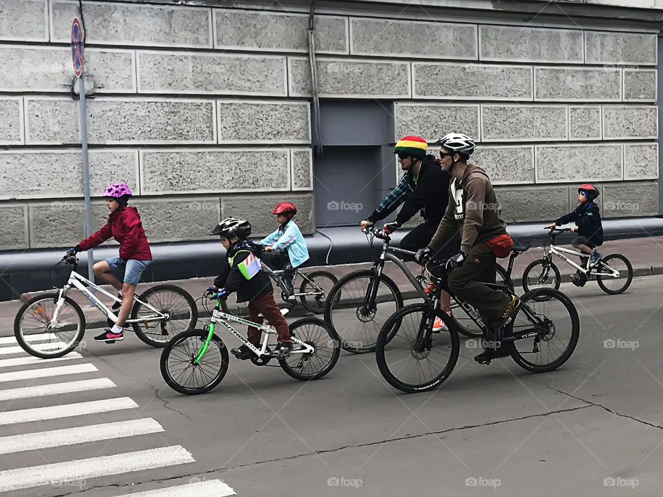 Two families with children having fun on bicycles 