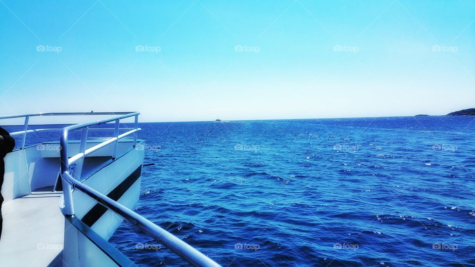 open waters. staring out at the horizon from the boat