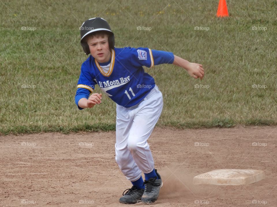 Young Baseball Player. Young Little League Baseball Player Running The Bases
