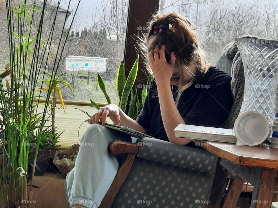 young girl sitting in conservatory