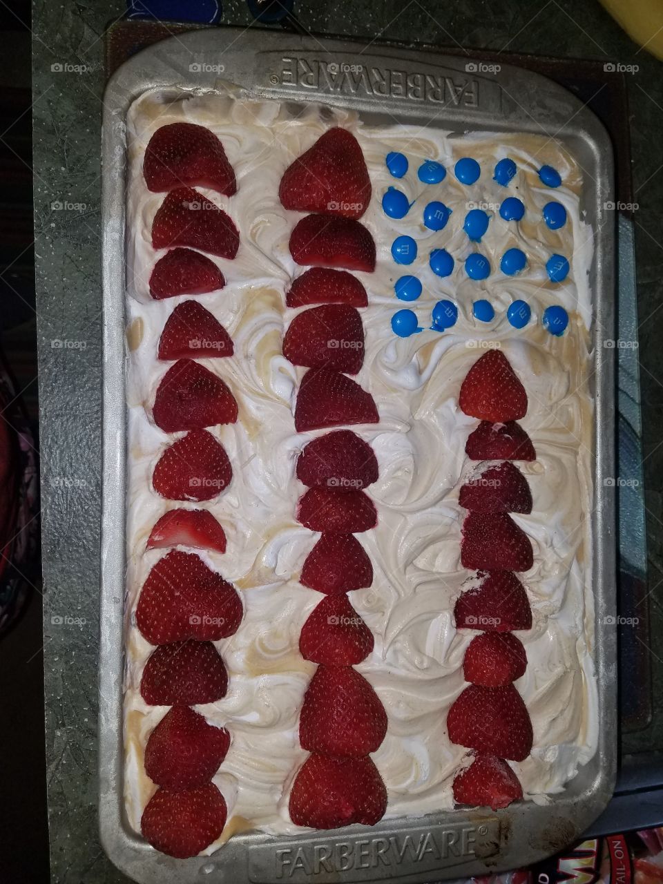 Peanut Butter Whipped Cream Flag Cake with blue M&Ms and strawberries!