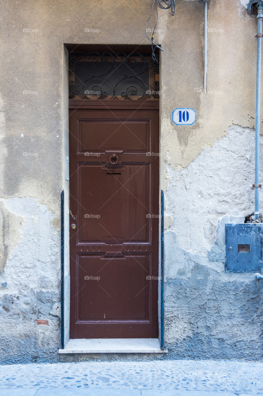 Old door in the city of Cefalu on Sicily.