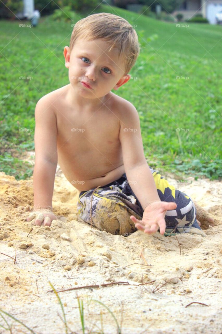 Portrait of a boy playing in sand