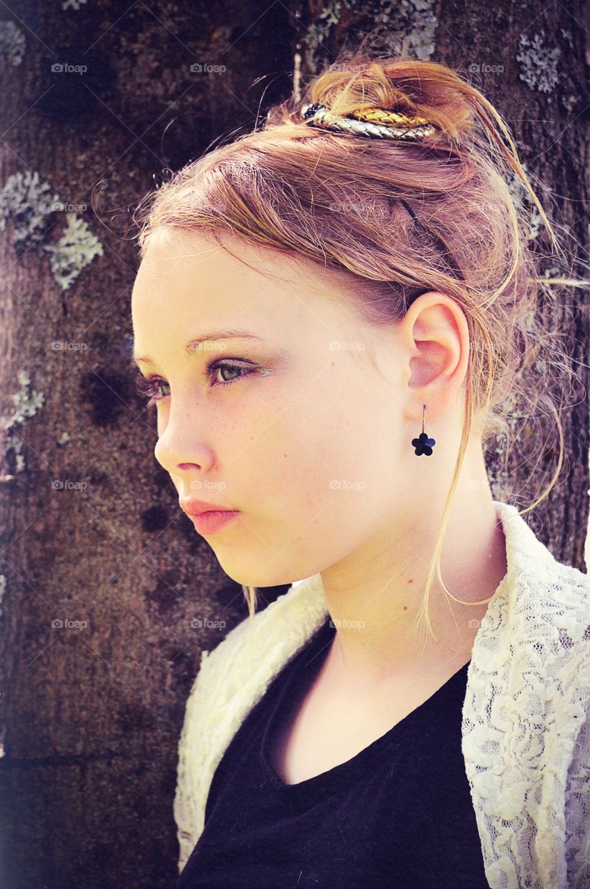 Girl leaning on the tree