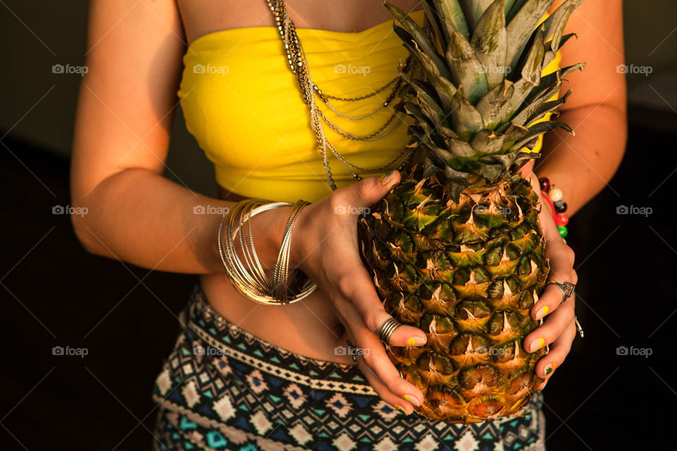 Hands with pineapple 