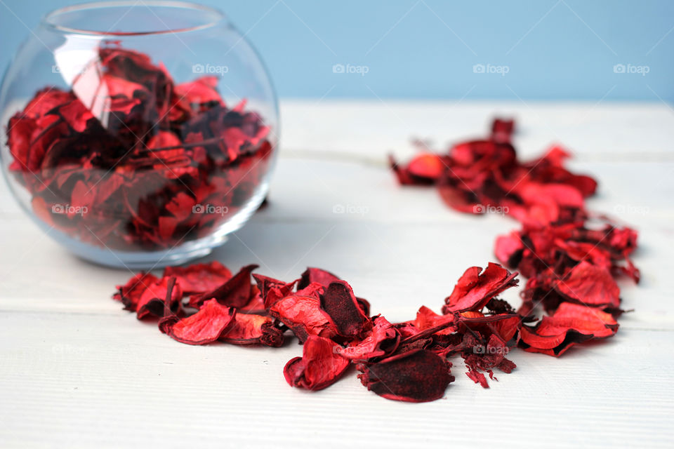 Rose petals on white table