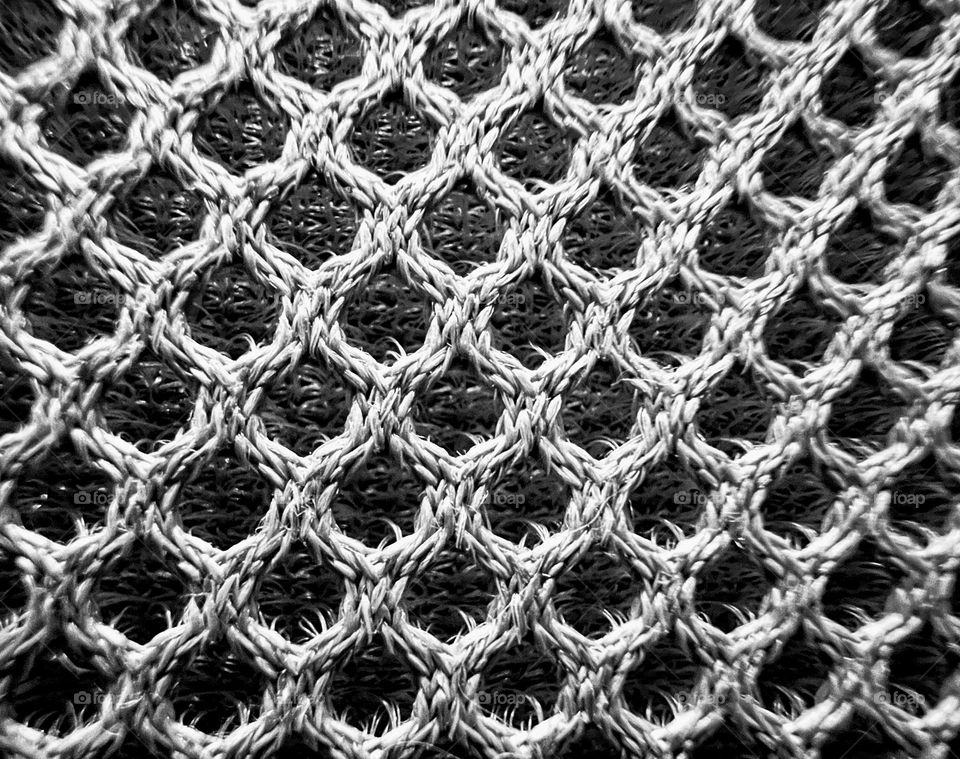 Black and white monochrome close up abstract futuristic mesh shape surface background