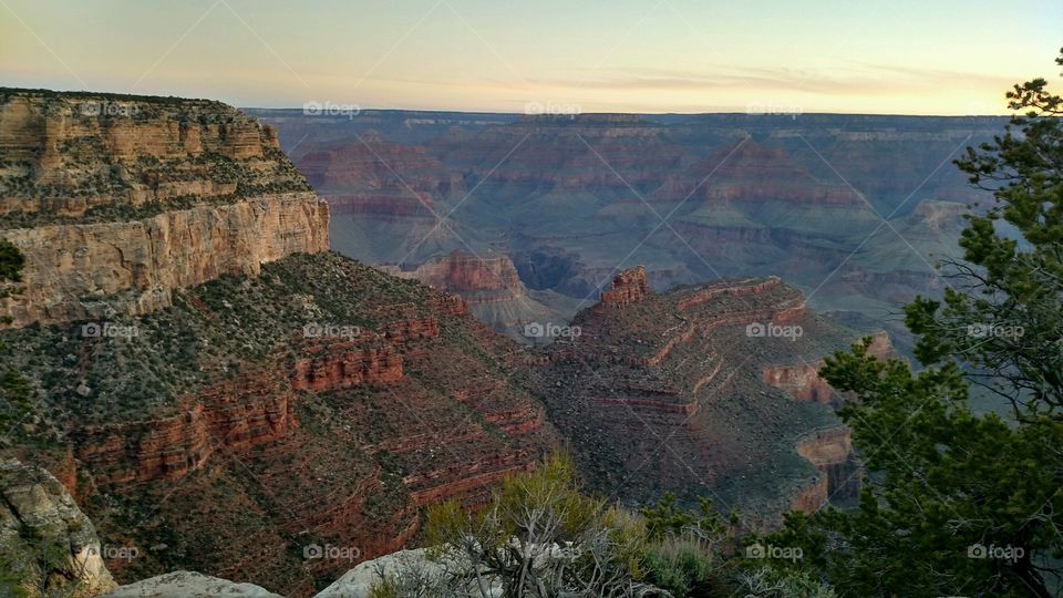 The Grand Canyon cast in the warm tones of an evening sunset in Arizona. 