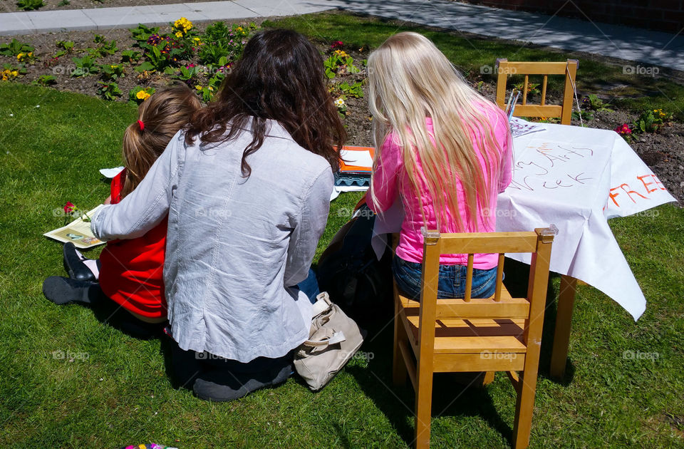 Mother and two girls doing crafts outside