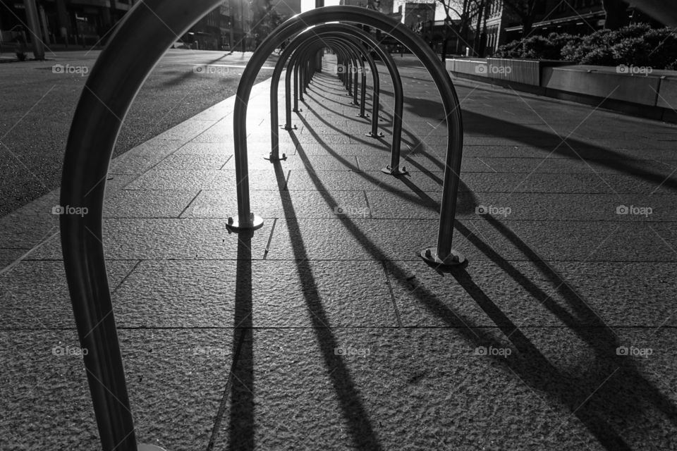 Monochrome image of u-shaped shadow in the magic hour on the street.