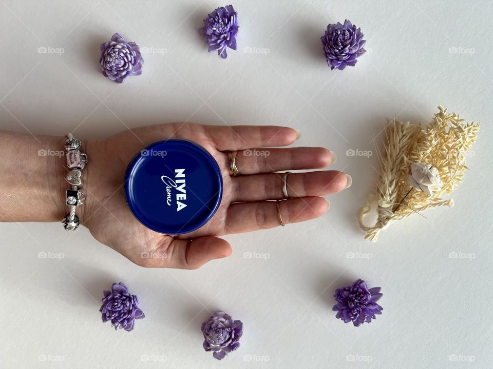 Nivea cosmetic, hand holding the Nivea cream. Famous beauty brand- Nivea.