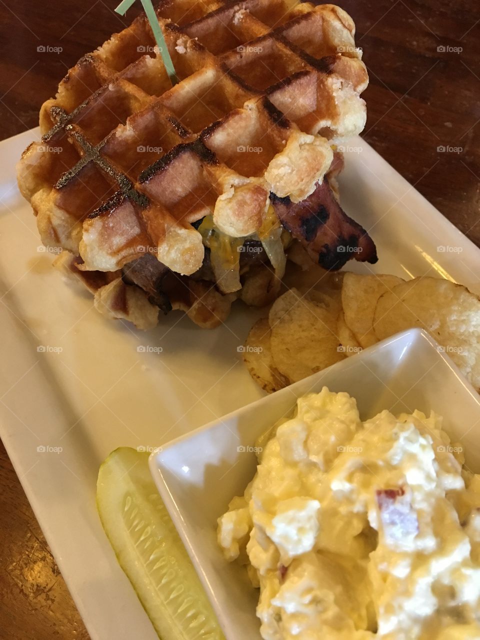 Cheeseburger on a waffle bun with potato salad side