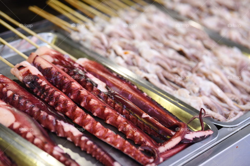 Asia China Beijing chinese strret food market at Wang Fu Jing. Octopus tentacle on spies