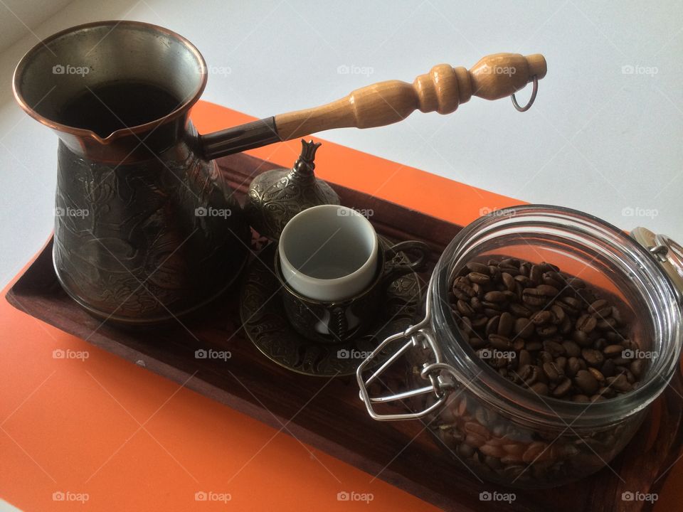 Old coffee pot with coffee beans