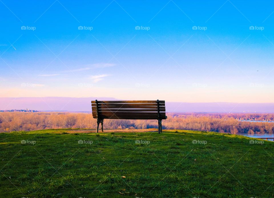 Wooden bench on the hillside with a view