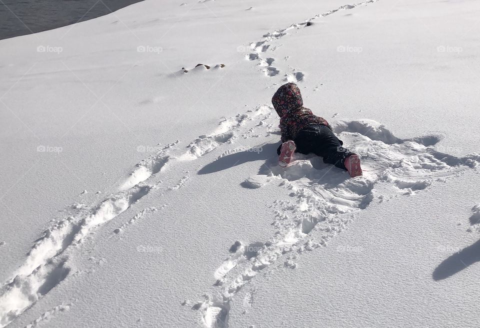 A Toddler Playing in the Snow