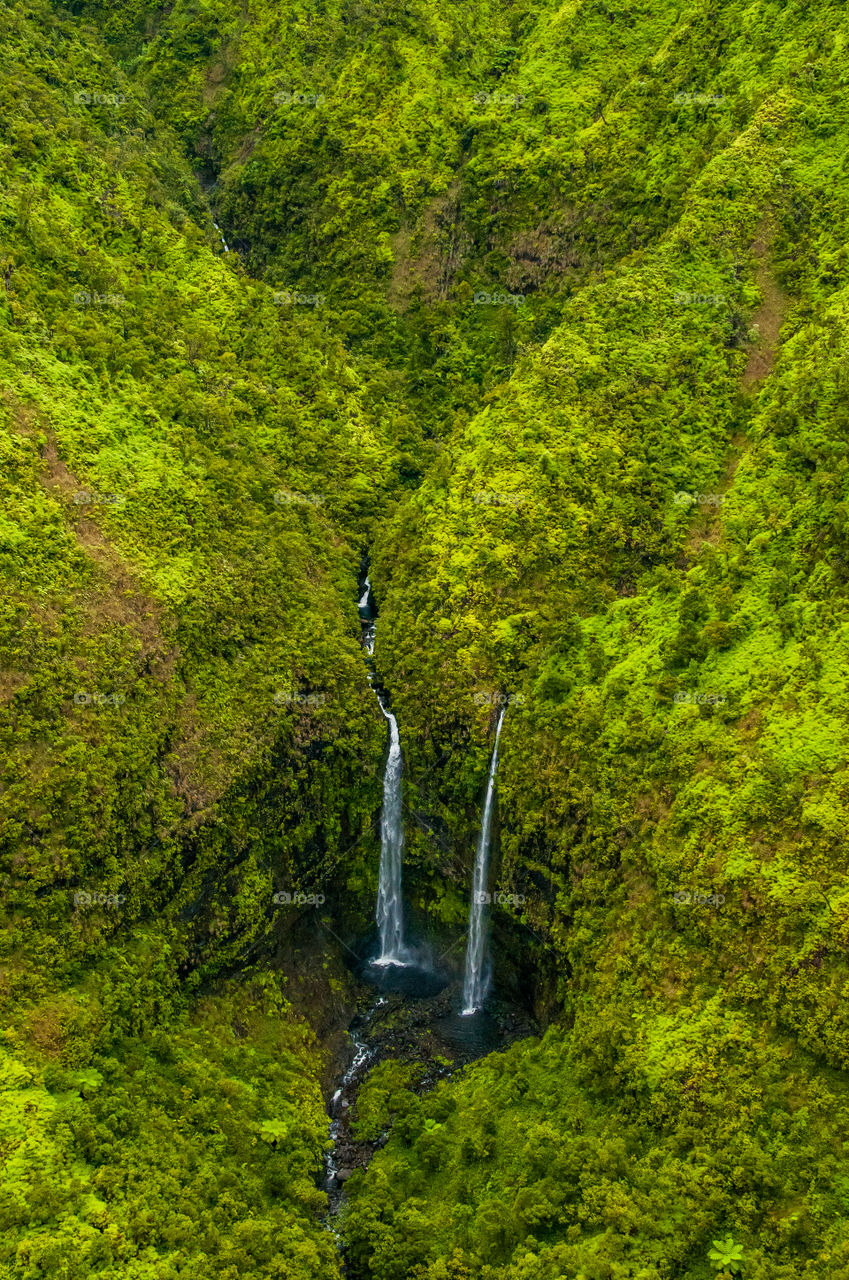 Aerial view of hidden waterfall in Kauai Hawaii.